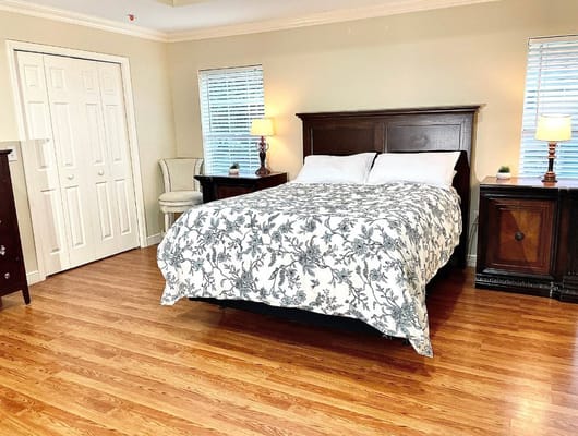 Bright interior of a resident room with a bed and furniture