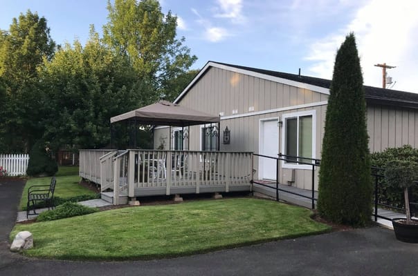 Exterior view of a senior care facility with outdoor seating