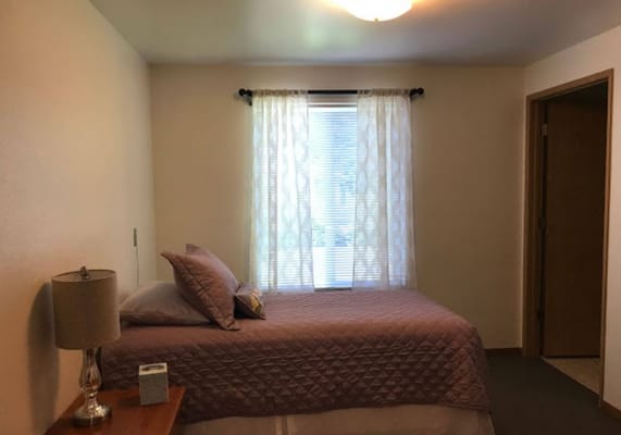 Cozy private resident room with a bed and lamp