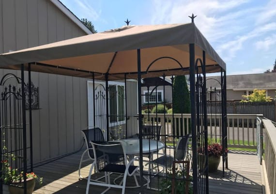 Outdoor gazebo with seating area in a serene setting