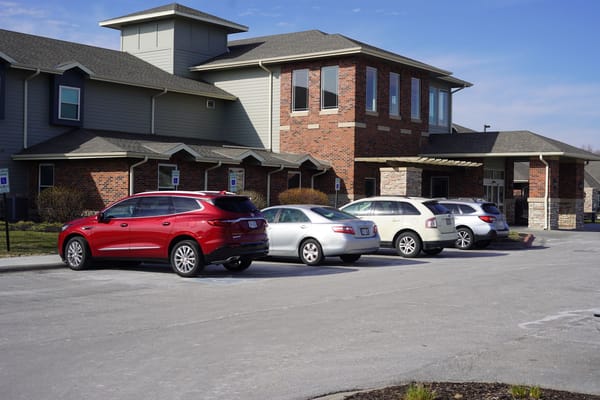 Exterior view of Heritage Pointe with parked cars