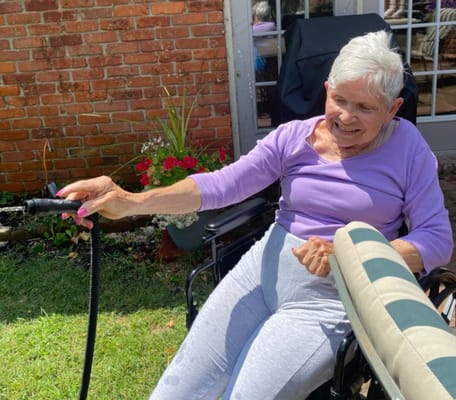 Resident enjoying time outdoors in a garden area
