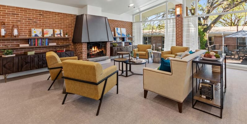 Bright common area with comfortable seating and a fireplace