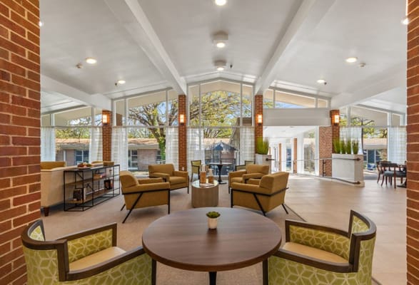 Bright common area with seating and large windows