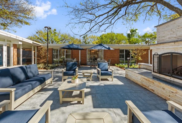 Outdoor patio area with seating and greenery