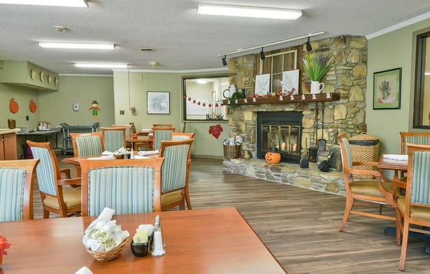 Cozy dining room with a fireplace and autumn decor