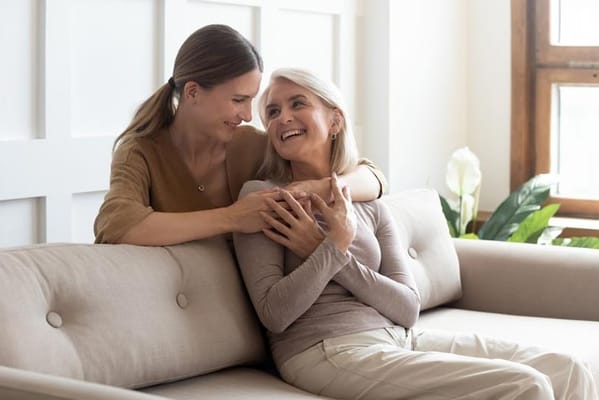 Two women enjoying time together on a couch