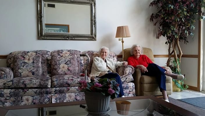 Two residents sitting in a cozy common area