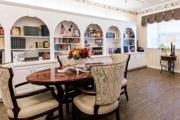 A cozy common area with bookshelves and seating