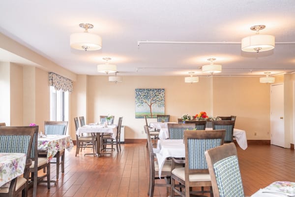 Dining room with tables set for residents