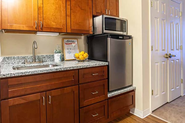 Modern kitchen area with wooden cabinets and appliances