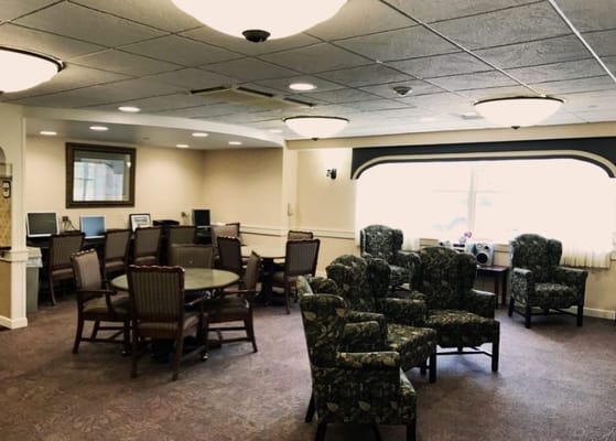 Seating area with chairs and computers in a senior living facility