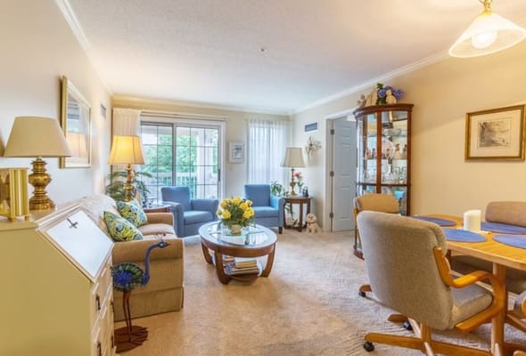 Bright and inviting living room with comfortable seating and dining area