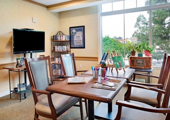 Bright common area with seating and activity supplies