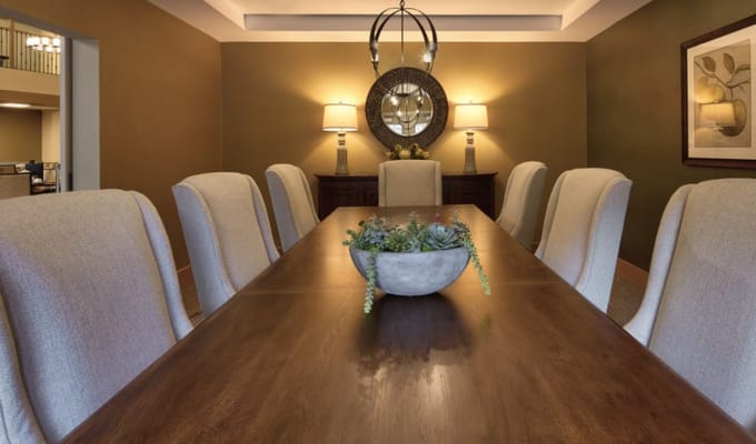 Elegant dining room with a long table and plants