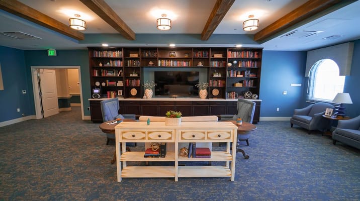 Common area in a senior living facility with bookshelves