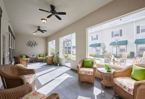 Cozy sunroom with wicker seating and plants