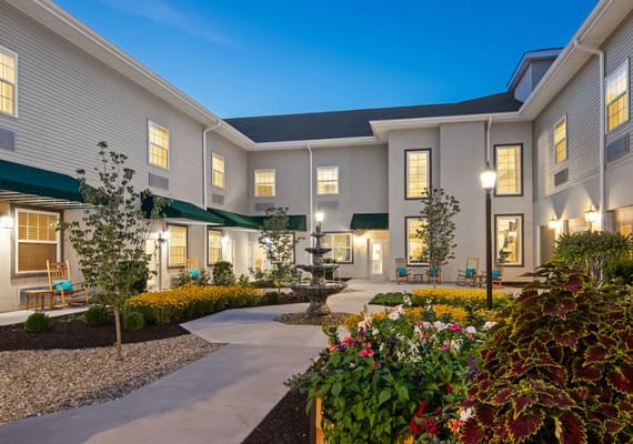 Sunset view of the courtyard with a fountain and flowers