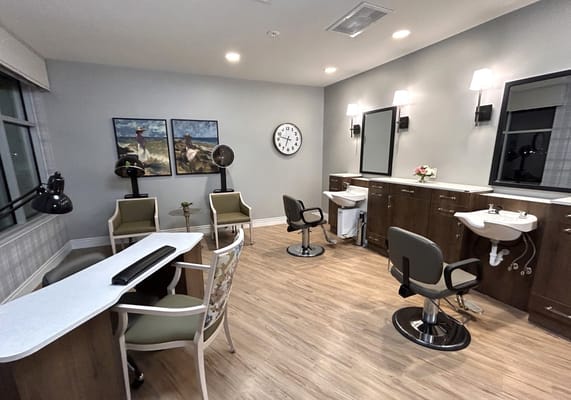 Hair salon area with salon chairs and mirrors
