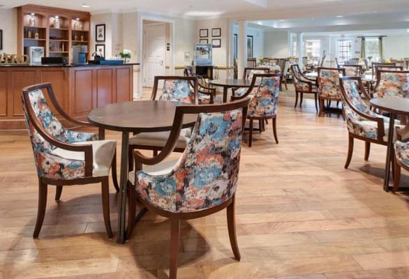 Interior view of a dining area with floral chairs