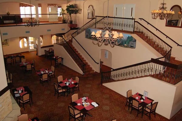 View of the dining area with tables and a staircase in Pennington Gardens.