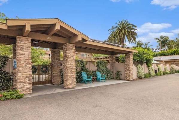 Front entrance with seating and palm trees