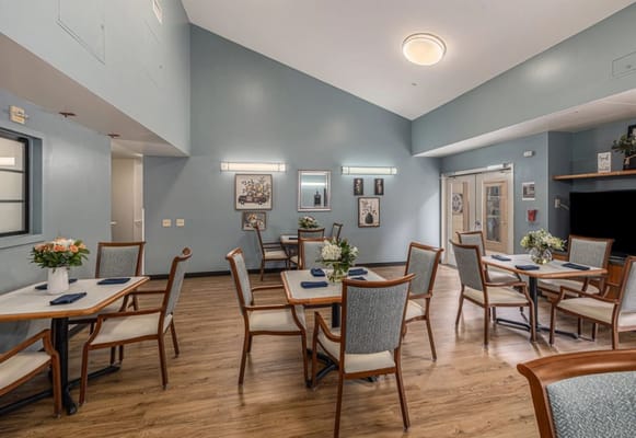 Bright dining room with tables and chairs set up
