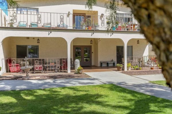 Exterior of Sea Cliff Assisted Living facility with patio and garden