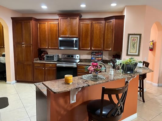 Bright kitchen with wooden cabinets and granite countertop