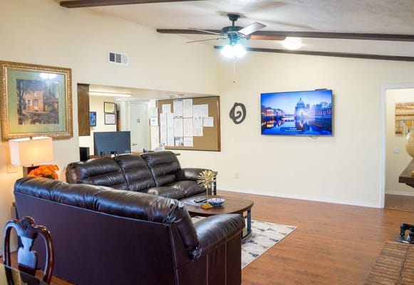 Cozy living room with leather sofas and a TV