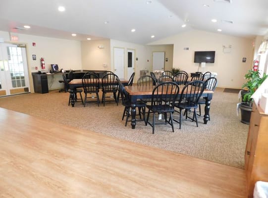 Large dining area with multiple black chairs and tables