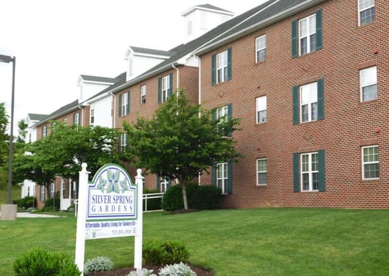 Exterior view of Silver Spring Gardens building with sign