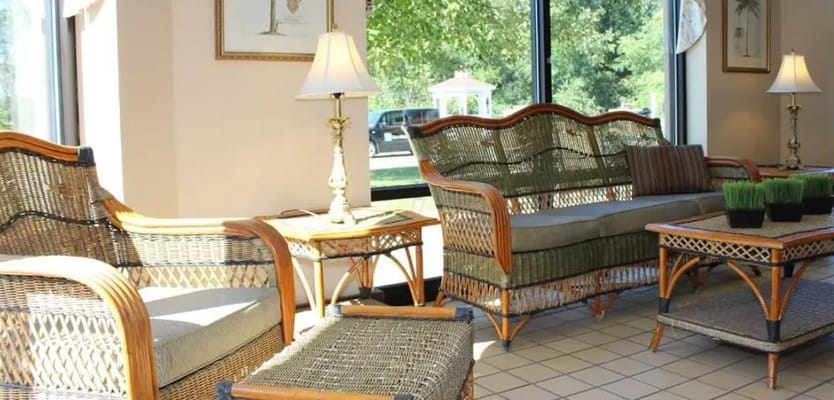 Lounge area with wicker furniture and lamps