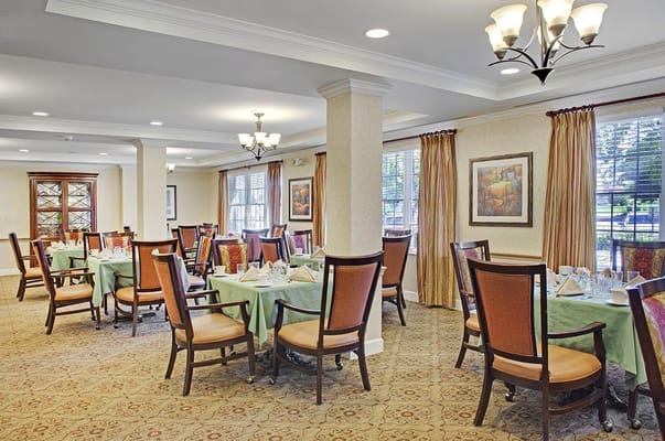 Well-decorated dining room with set tables at Sunrise of Edina