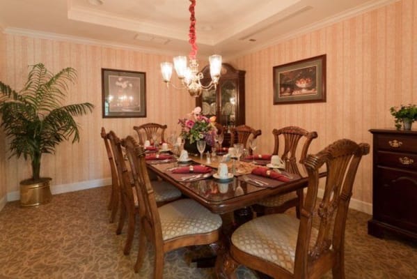 A beautifully set dining table in a senior living facility dining room.