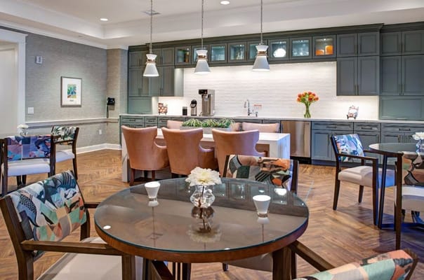 A welcoming common area with dining tables and a kitchenette.