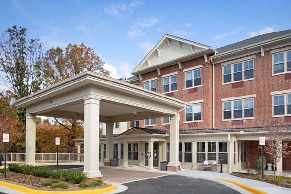 Exterior view of the entrance at Sunrise of Fairfax, showcasing the building's architecture.