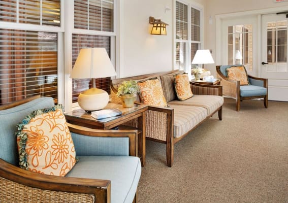 A living room area with comfortable seating and decorative pillows