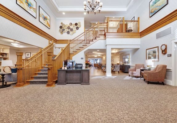 Spacious and inviting lobby with staircase and reception area
