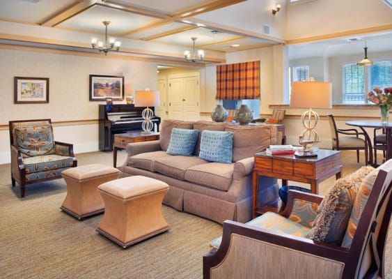Inviting living room featuring comfortable seating and a piano.