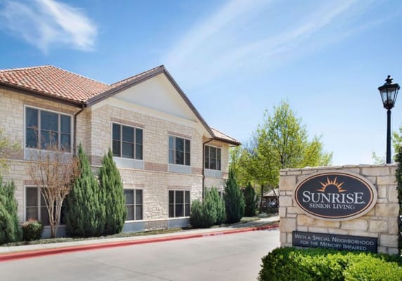 Exterior of Sunrise Senior Living facility with signage