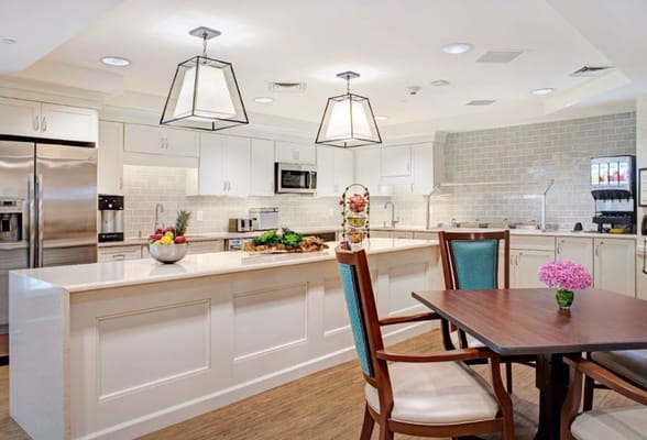 Bright kitchen area with a dining table and fruit display