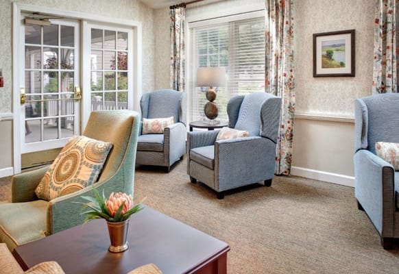 Comfortable seating area with blue chairs and a small table