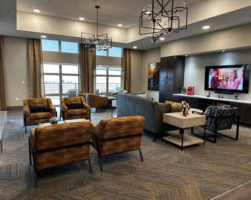 Cozy lounge area with chairs and a TV