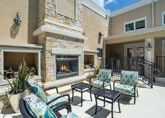 Cozy outdoor lounge with a fireplace and seating