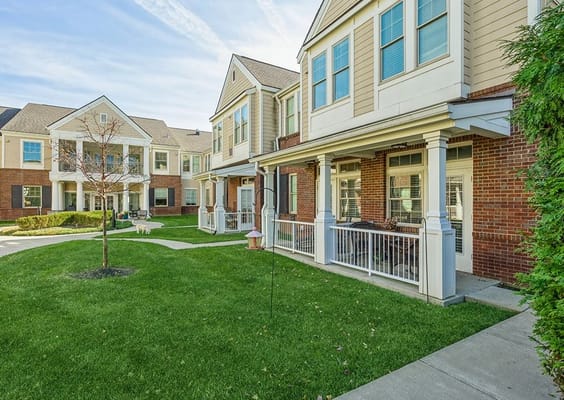 Exterior view of The Bridges at Bent Creek with green lawn and residential-style buildings.