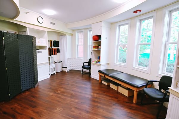 Interior view of a spacious room with seating and natural light