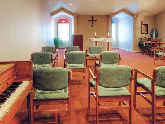 Chapel interior with chairs and altar at The Heritage at College View.