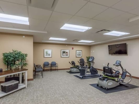 Fitness room with exercise equipment and seating area