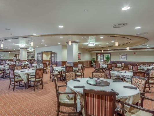 Spacious dining area with tables and chairs in The Heritage at Legacy.